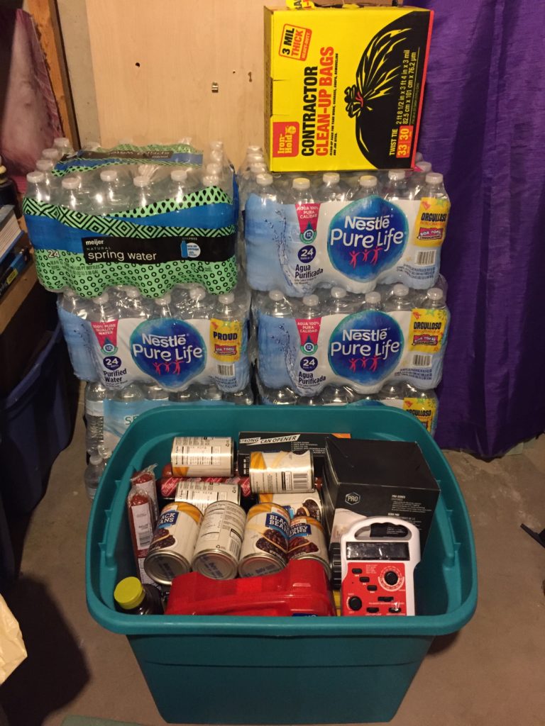 Preparedness Kit with cases of water and garbage bags